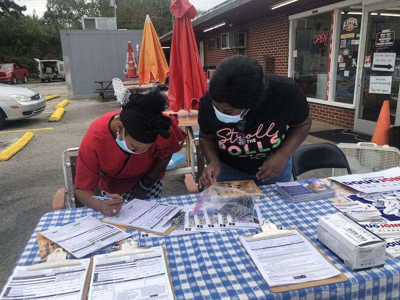 a volunteer helps register a voter